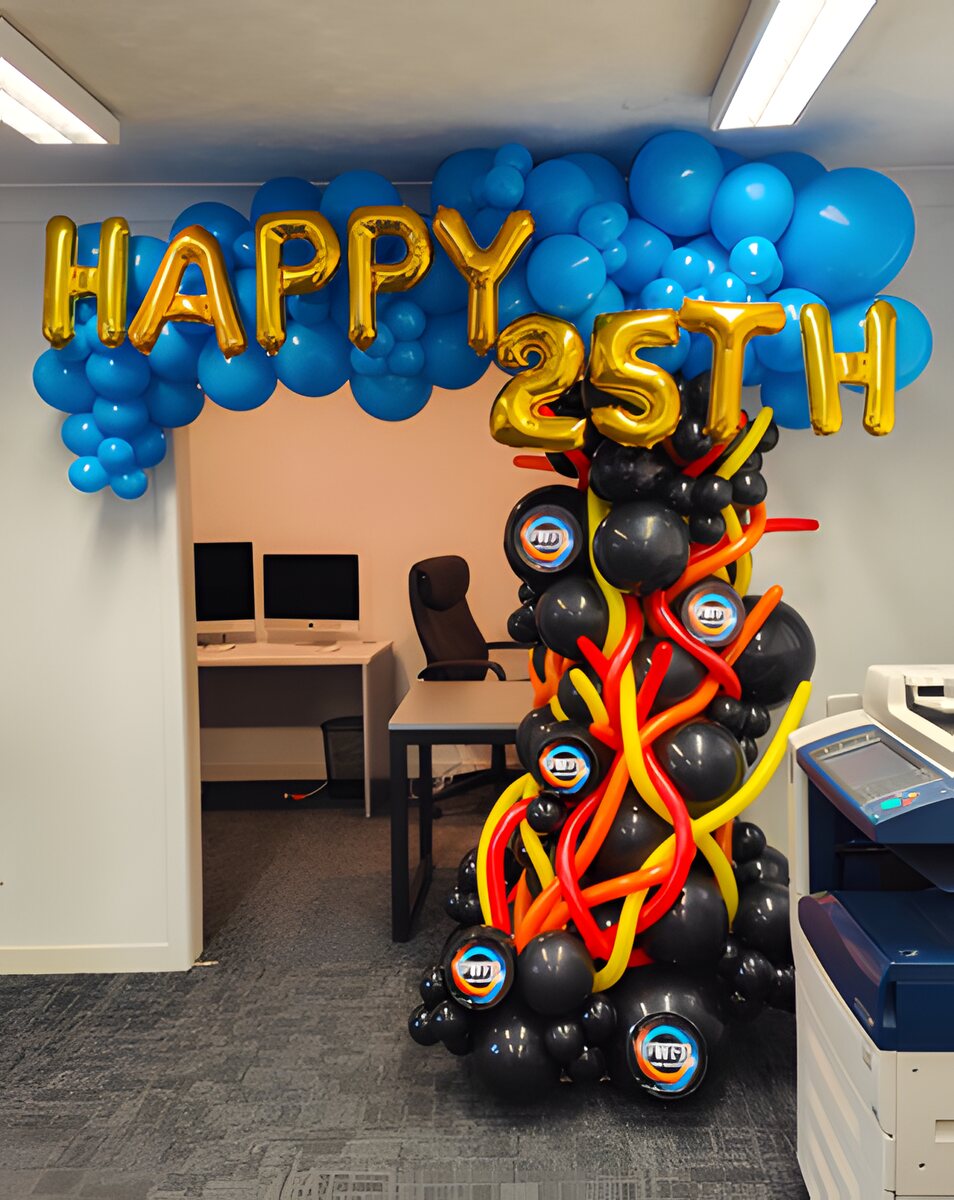Happy 25th balloon arch and column in an office