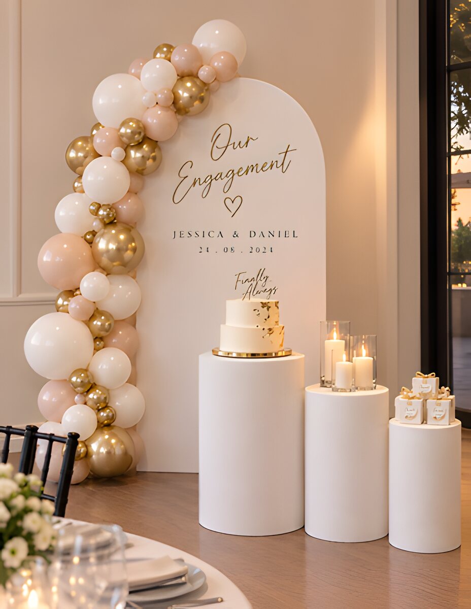 Engagement balloon arch beside a cake table